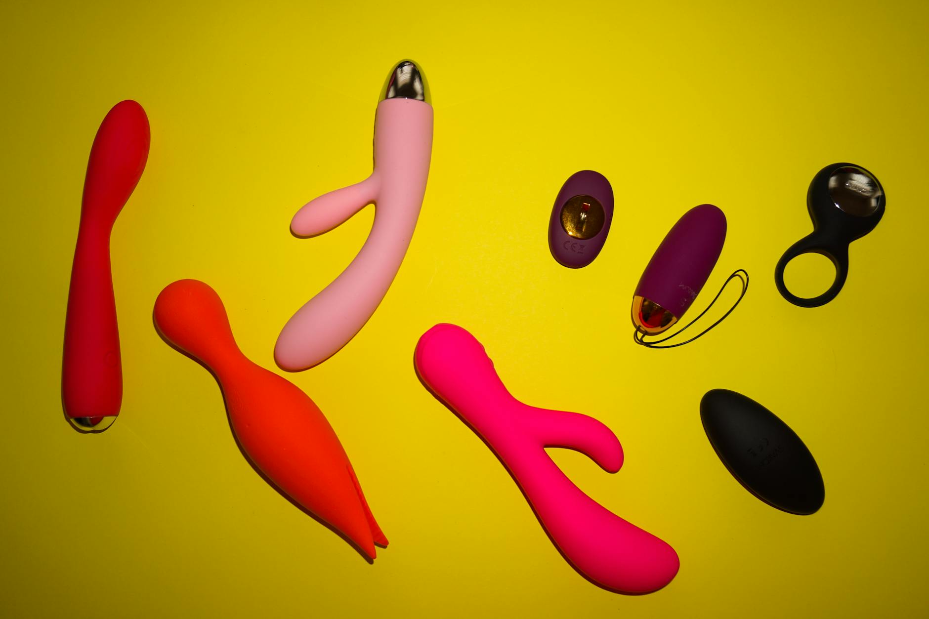 A teal lemon vibrator resting on smooth white silk, representing modern intimacy and design.