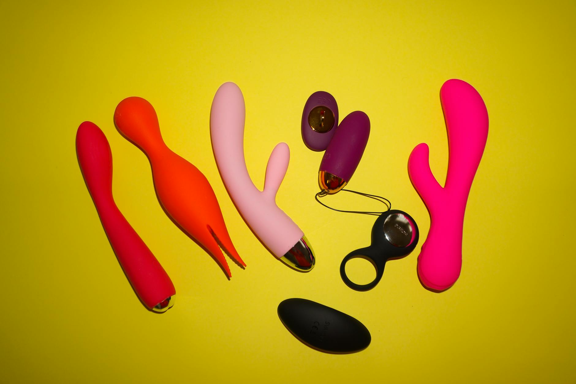 Hands holding a soft-colored silicone vibrator, representing self-care and intimate wellness after parenthood